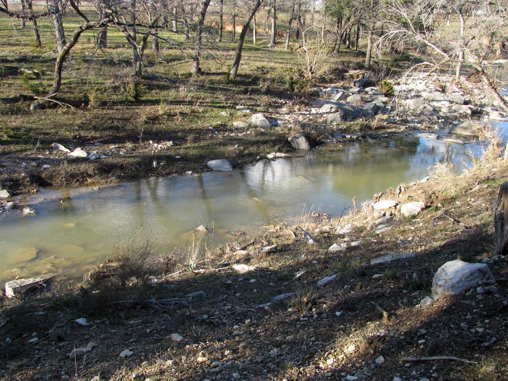 675 Fossil Rdg Court Evant, TX 76525 - Photo 14 of 26 a view of a lake with houses