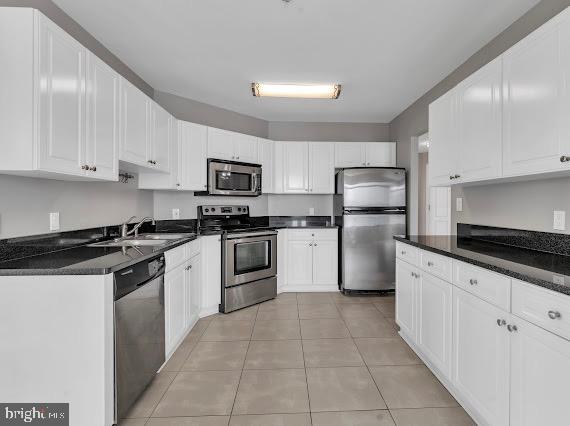 100 Harborview Drive, Unit 202 Baltimore, MD 21230 - Photo 14 of 25 a kitchen with granite countertop a sink a stove top oven and refrigerator