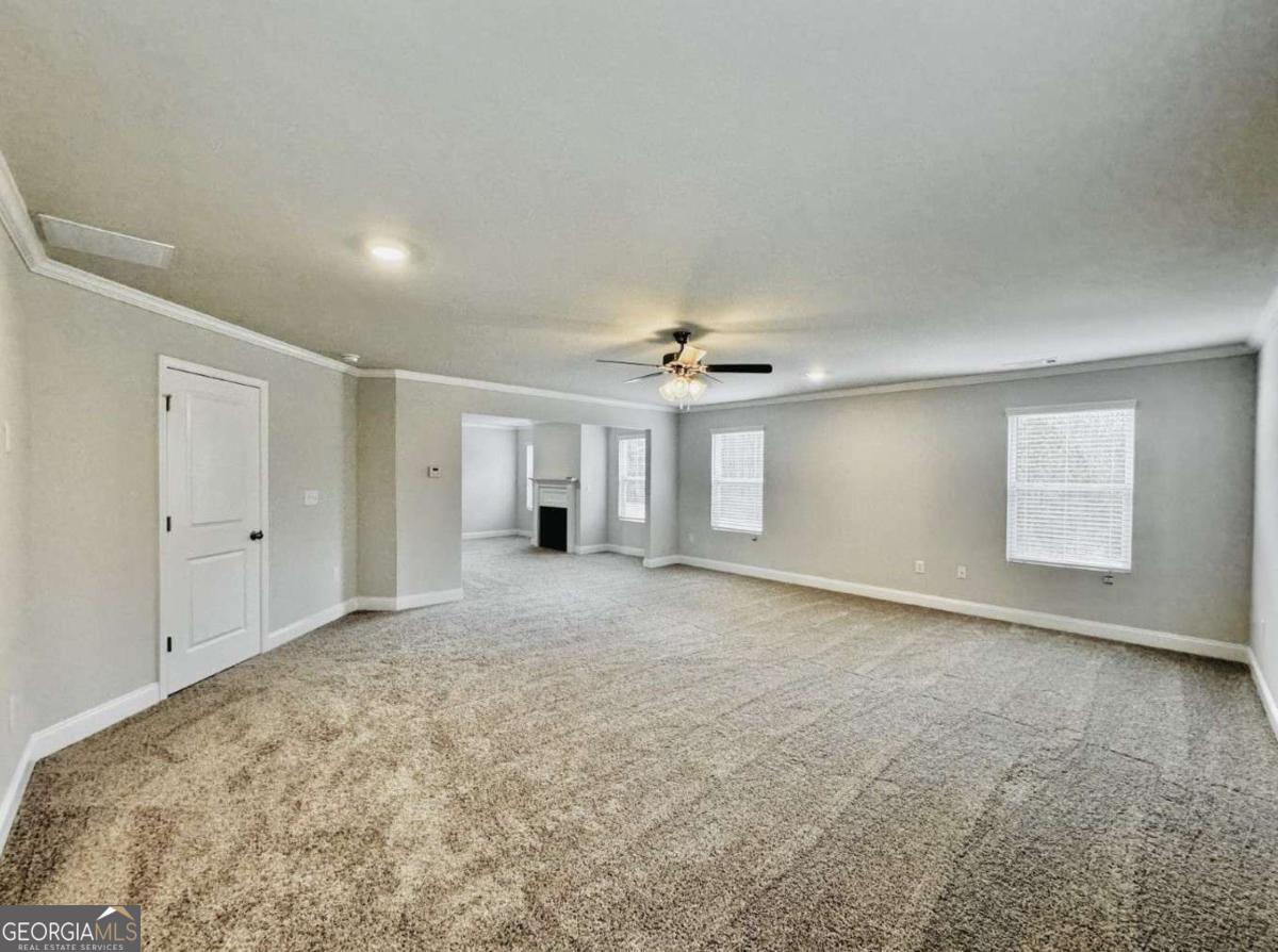 59 Observation Court, Unit 129 Dallas, GA 30132 - Photo 14 of 22 en empty room with windows and ceiling fan