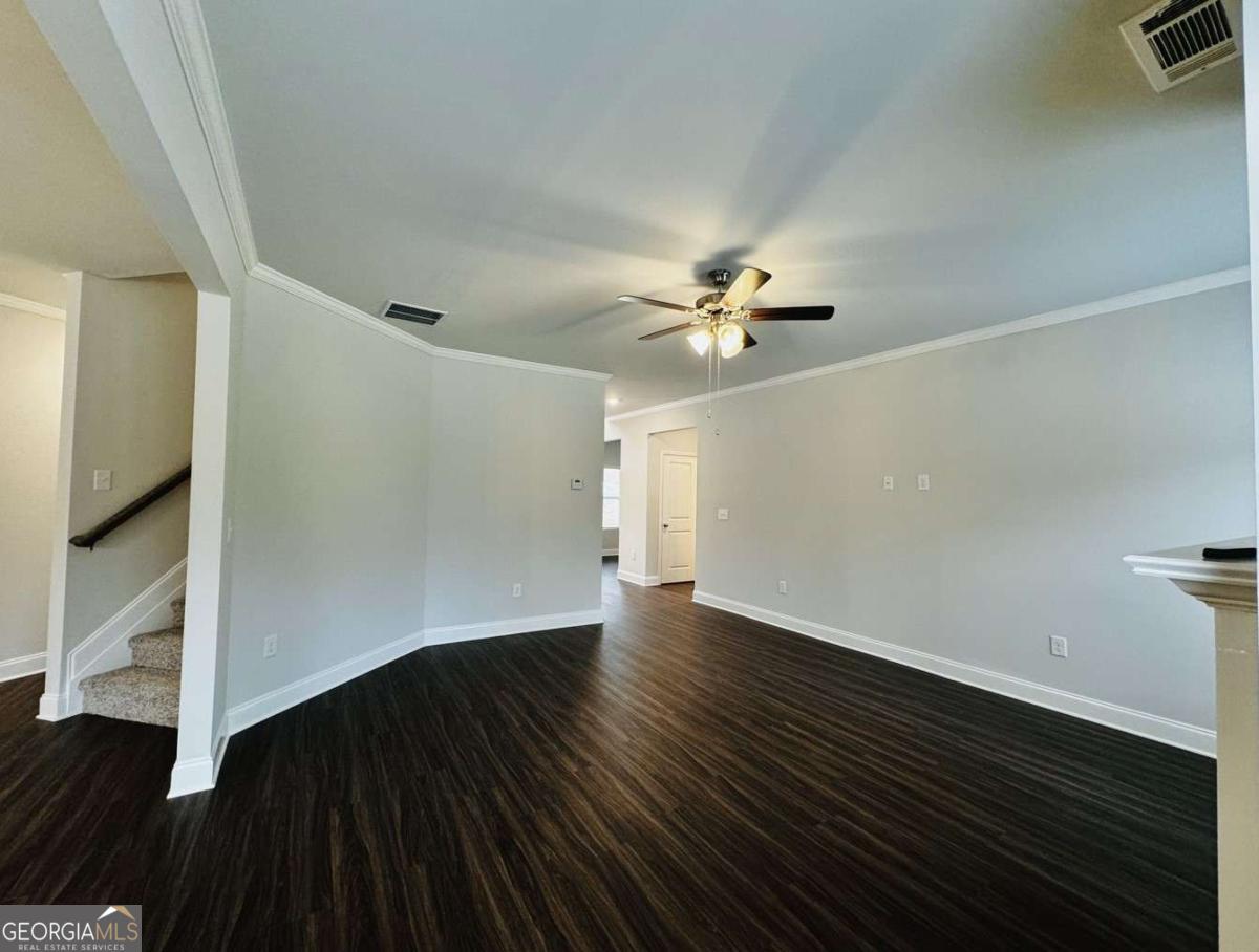 59 Observation Court, Unit 129 Dallas, GA 30132 - Photo 10 of 22 an empty room with wooden floor chandelier fan and windows