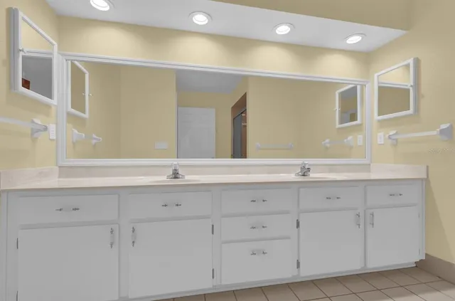 a spacious bathroom with a shower sink and mirror