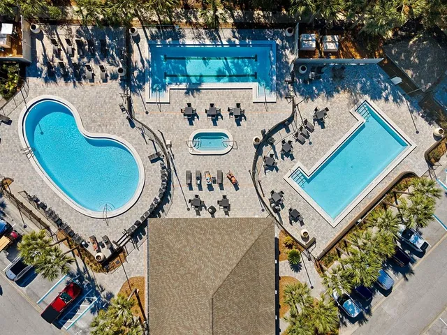 an aerial view of a house with garden space and swimming pool