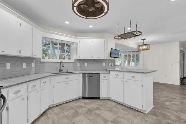 a kitchen with cabinets and window