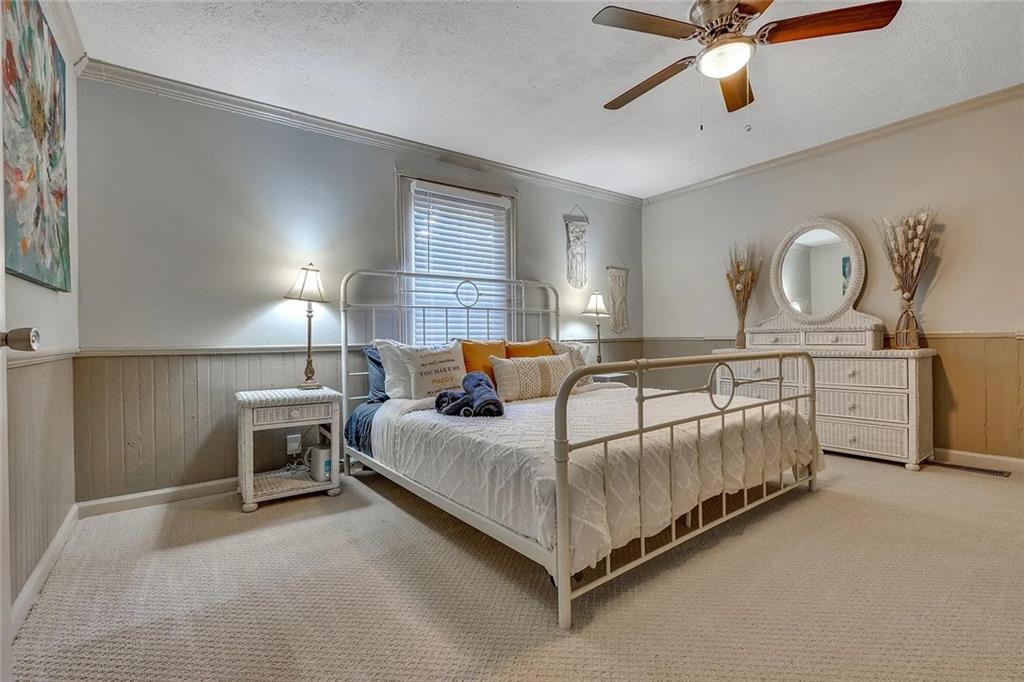 72 Kenyon Street Southeast, Unit 72 Atlanta, GA 30316 - Photo 8 of 10 a bedroom with a bed window and a chandelier