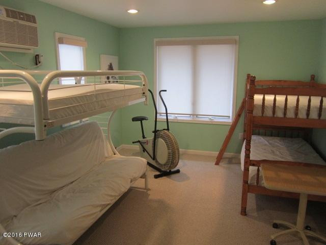 203 Westcolang Road Lackawaxen, PA 18435 - Photo 11 of 15 a room with pool table gym equipment and windows