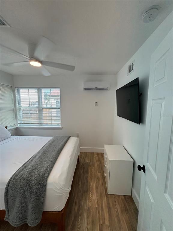 14141 Gulf Boulevard, Unit 5 Madeira Beach, FL 33708 - Photo 8 of 14 a living room with furniture and a flat screen tv