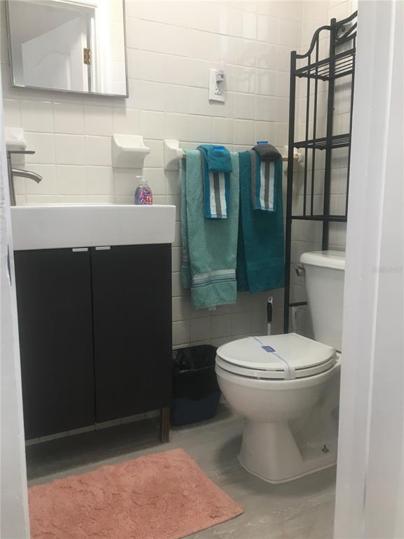 14141 Gulf Boulevard, Unit 5 Madeira Beach, FL 33708 - Photo 10 of 14 a bathroom with a sink toilet and shower