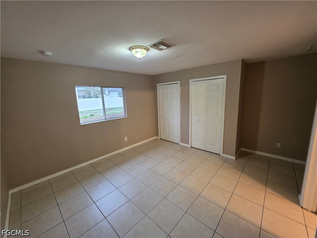 4647 24th Street Southwest Lehigh Acres, FL 33973 - Photo 11 of 12 a view of an empty room with a window