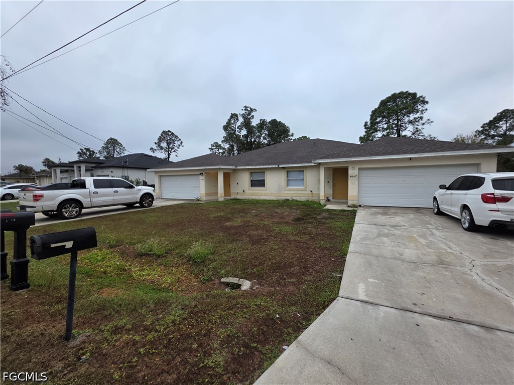 4647 24th Street Southwest Lehigh Acres, FL 33973 - Photo 2 of 12 a view of a car parked in front of a house