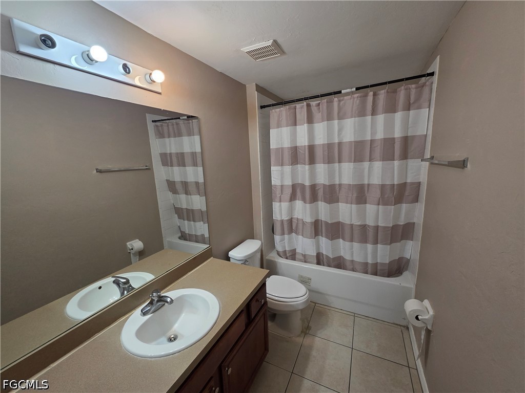 4647 24th Street Southwest Lehigh Acres, FL 33973 - Photo 9 of 12 a bathroom with a sink a toilet a mirror and shower