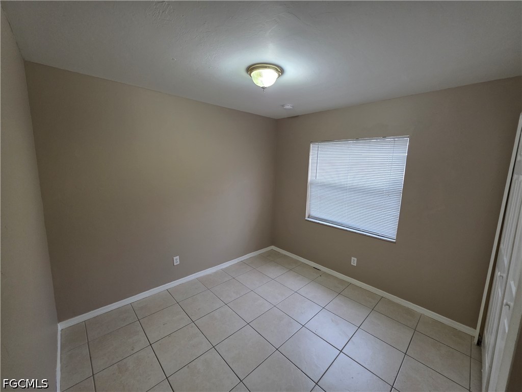 4647 24th Street Southwest Lehigh Acres, FL 33973 - Photo 10 of 12 an empty room with windows