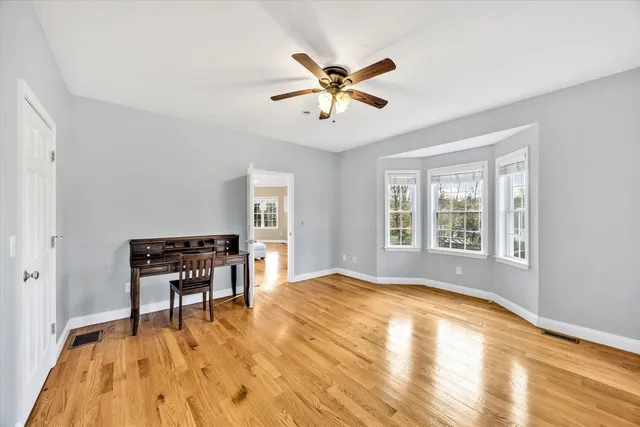 a workspace with wooden floor and windows