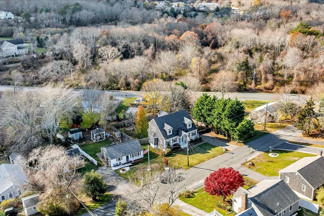 an aerial view of a house with a yard