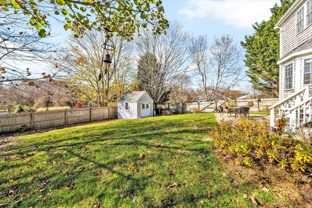 a view of yard with tree in the background