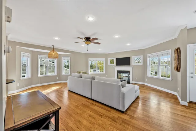 a living room with furniture and a wooden floor