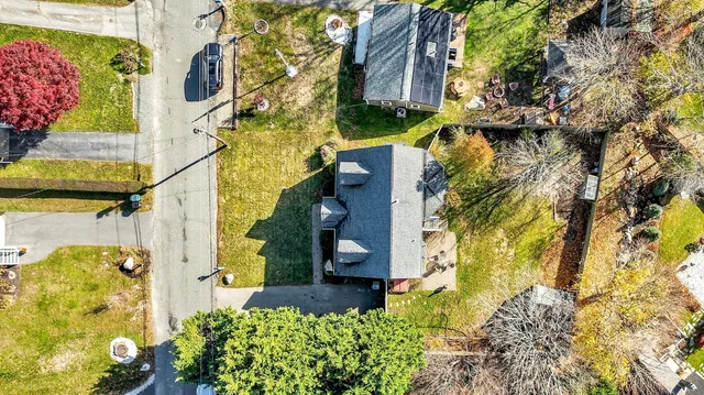 a aerial view of a house with a yard and garden