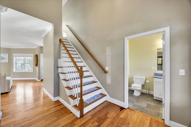 a view of a hallway with wooden floor and entryway