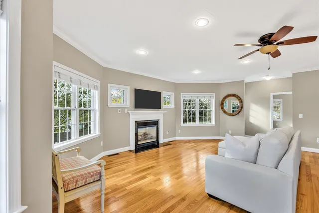 a living room with furniture a fireplace and a flat screen tv