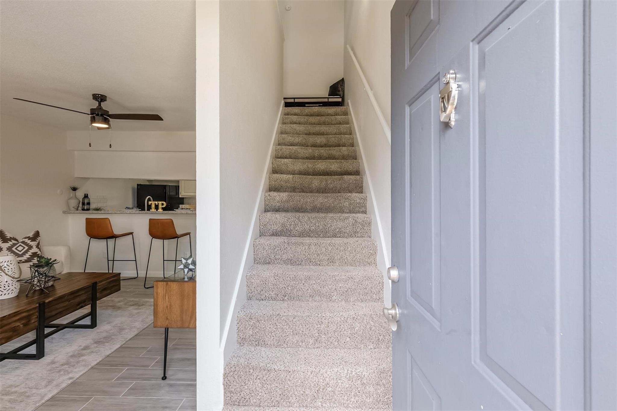 8162 Richmond Avenue, Unit 901 Houston, TX 77063 - Photo 17 of 33 a view of staircase with lots of frames on wall and a potted plant