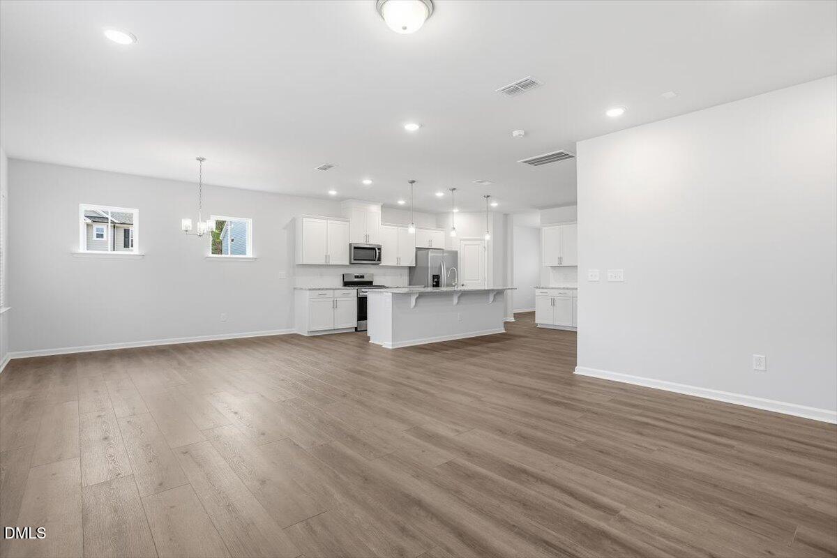 465 Grange Farm Place Raleigh, NC 27603 - Photo 19 of 44 a view of kitchen with wooden floor