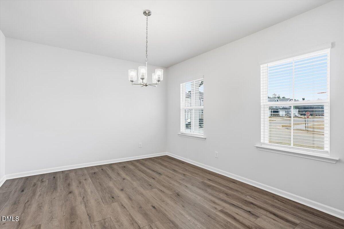 465 Grange Farm Place Raleigh, NC 27603 - Photo 28 of 44 a view of a room with wooden floor chandelier and windows