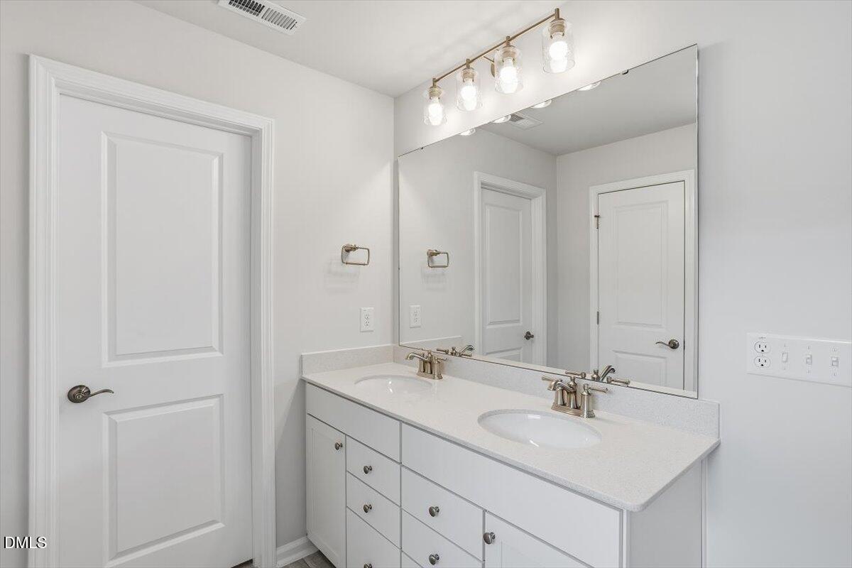 465 Grange Farm Place Raleigh, NC 27603 - Photo 36 of 44 a bathroom with a sink double vanity and a mirror