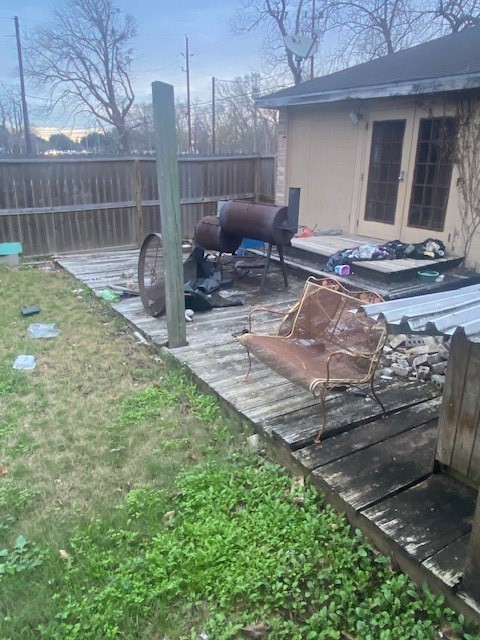 5204 Knight Road Rosharon, TX 77583 - Photo 5 of 12 Inside the fence is a small grass area with wood deck.
