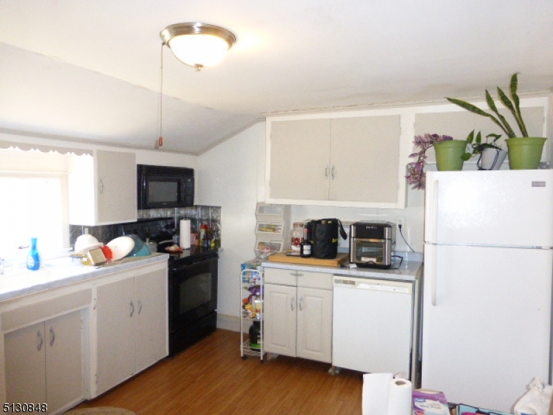 9 New Row Road, Unit A Hibernia, NJ 07842 - Photo 11 of 28 a kitchen with a sink a refrigerator and cabinets