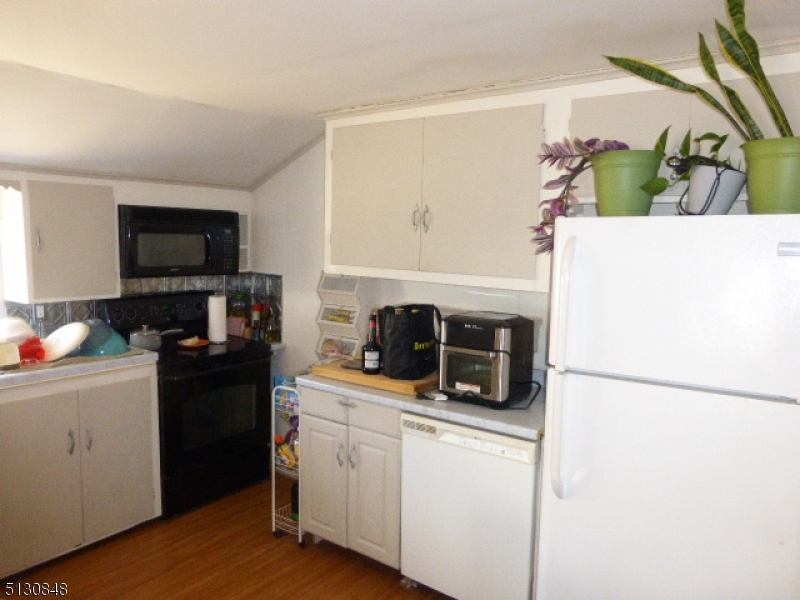 9 New Row Road, Unit A Hibernia, NJ 07842 - Photo 14 of 28 a kitchen with stainless steel appliances a stove a microwave and a hard wood floors