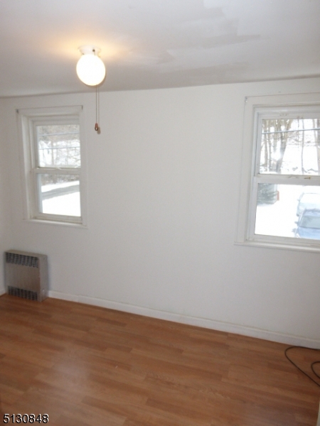 9 New Row Road, Unit A Hibernia, NJ 07842 - Photo 21 of 28 an empty room with wooden floor and windows