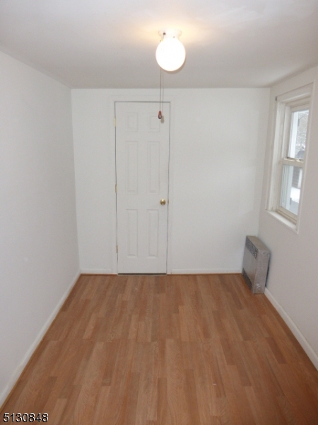 9 New Row Road, Unit A Hibernia, NJ 07842 - Photo 23 of 28 a view of an empty room with wooden floor and a window