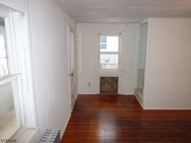 9 New Row Road, Unit A Hibernia, NJ 07842 - Photo 9 of 28 a view of an empty room with wooden floor and a window