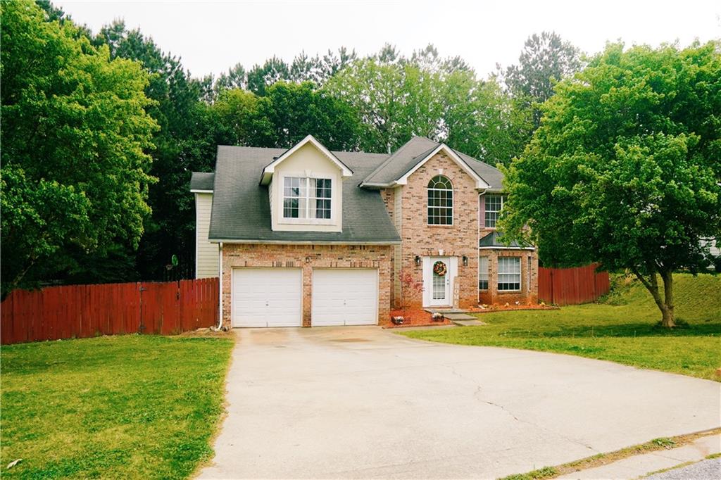 4590 Galleon Crossing Decatur, GA 30035 - Photo 1 of 1 a front view of a house with a yard and trees