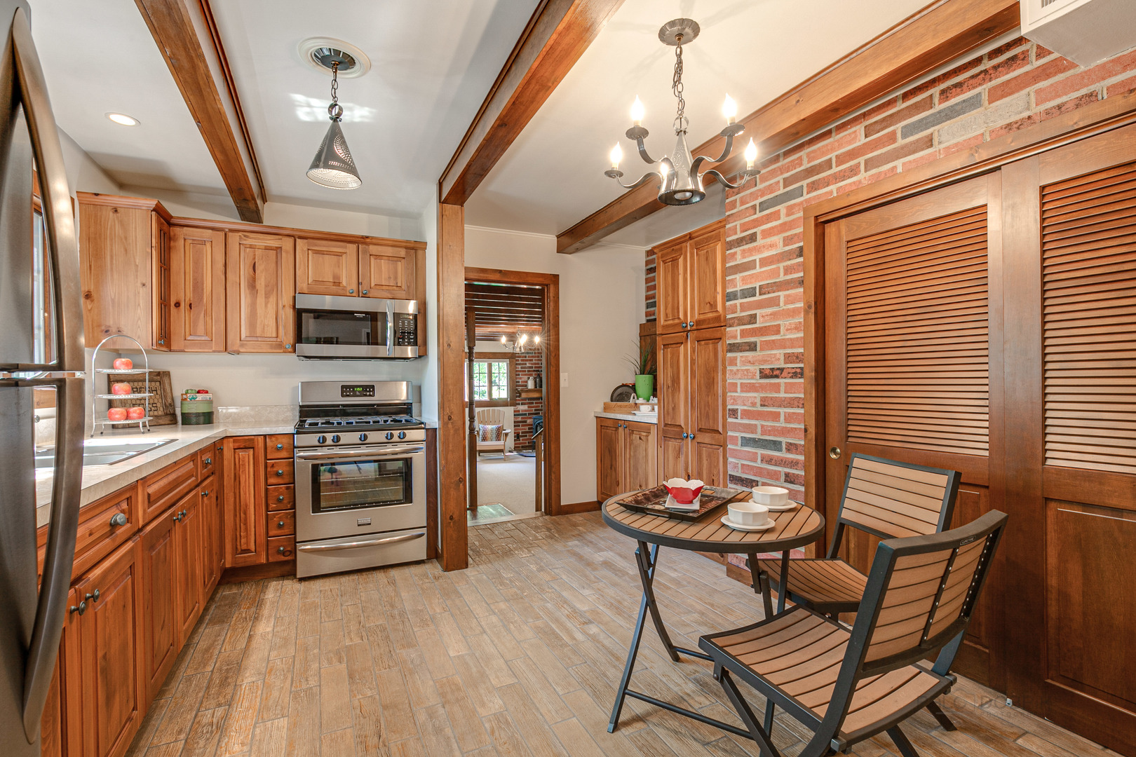 38 Golfview Road Lake Zurich, IL 60047 - Photo 10 of 27 a kitchen with stainless steel appliances kitchen island granite countertop a stove a refrigerator a sink dishwasher a dining table and chairs with wooden floor