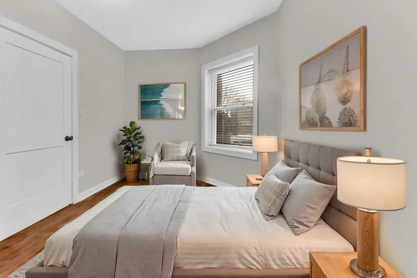 a bedroom with a bed and a window