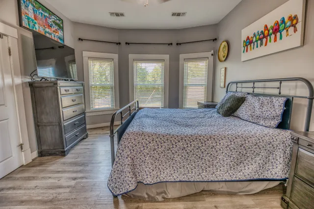 a large bed sitting in a bedroom next to a window