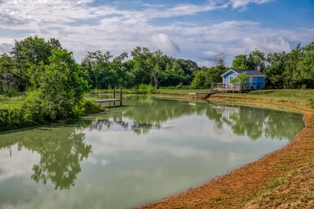a view of a lake with a house in the background