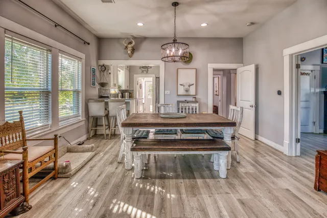 a kitchen with a stove a counter space a large window and furniture