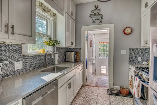 a bathroom with a sink a mirror and a shower