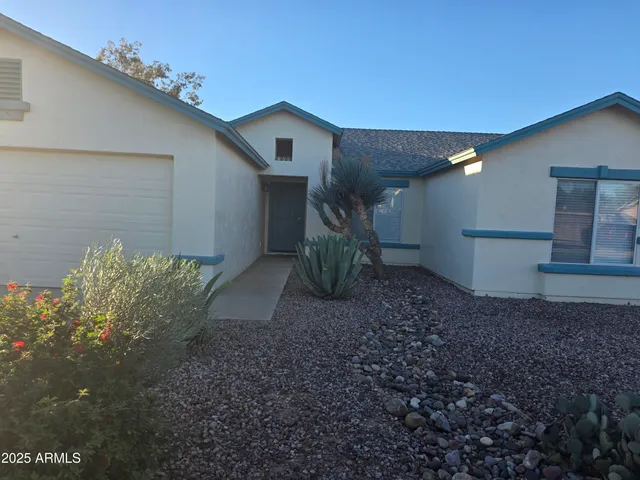 a view of a house with a yard and garage