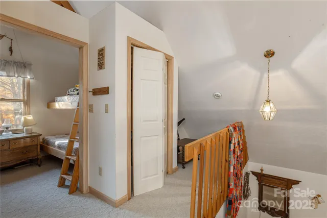 a view of a bedroom with a bed and a window