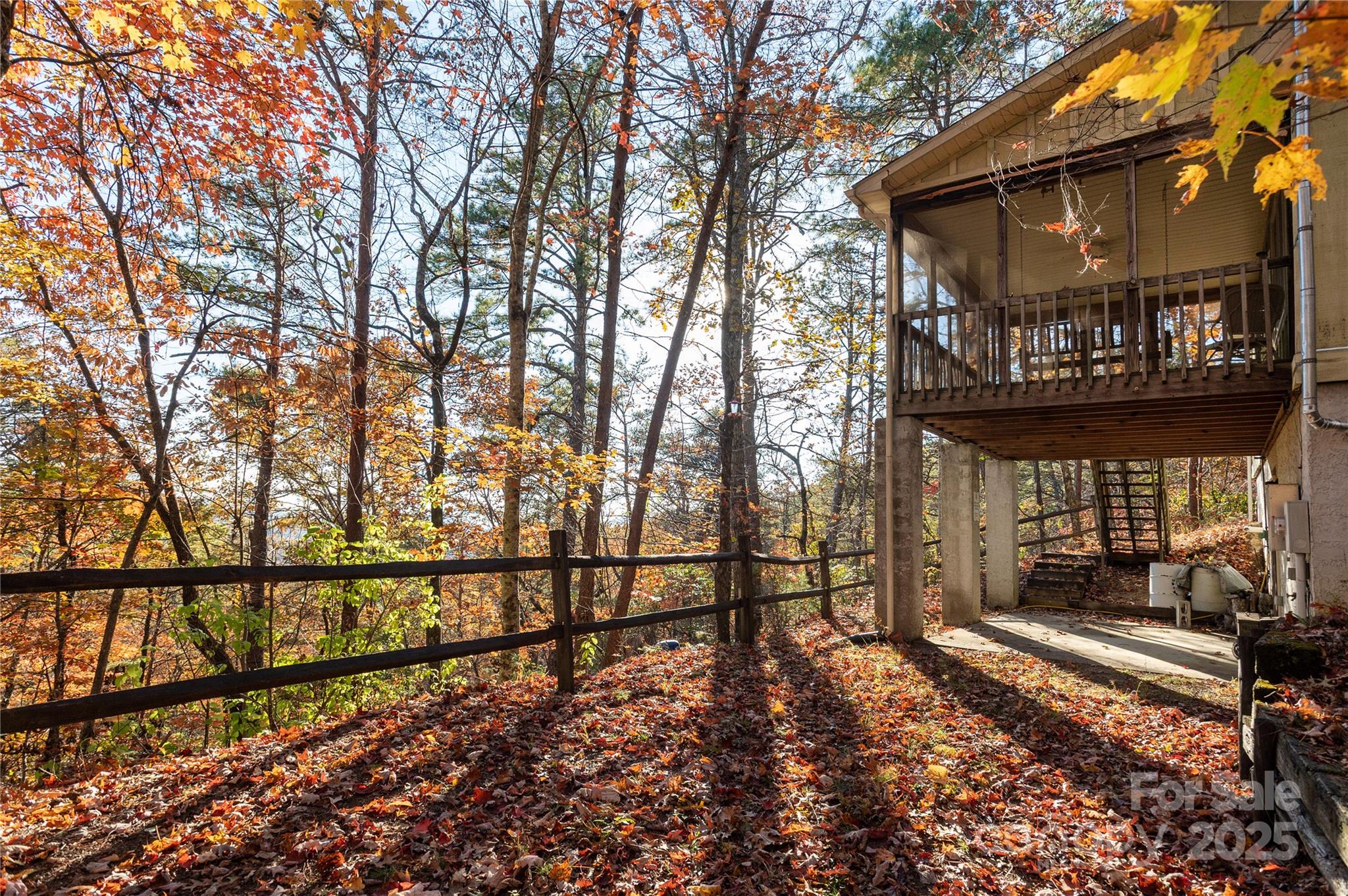 2355 Round Mountain Road Brevard, NC 28712 - Photo 25 of 27 a view of a house with large windows and wooden fence
