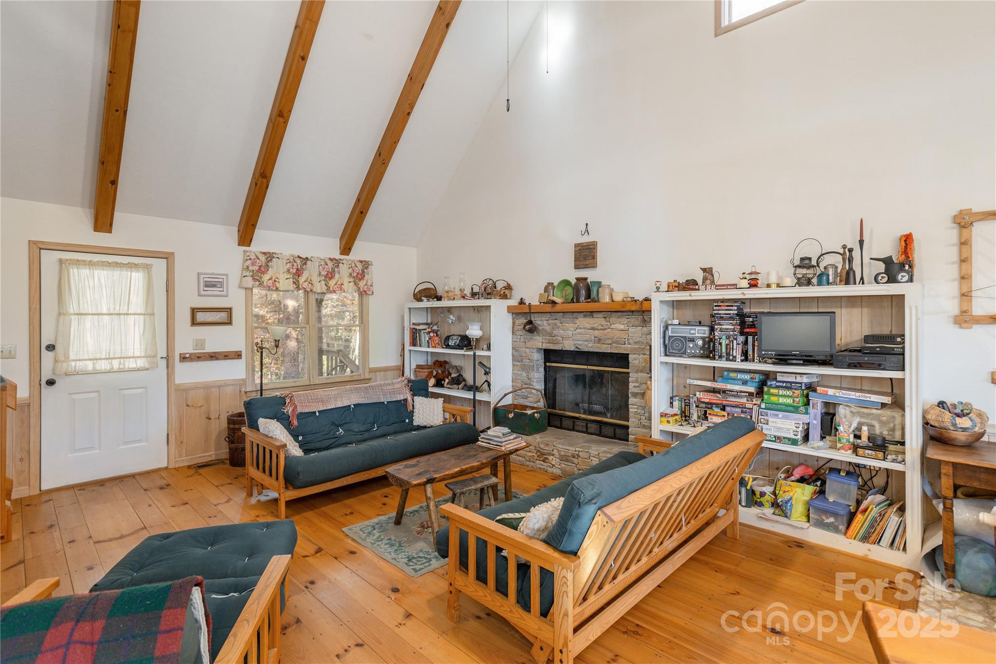2355 Round Mountain Road Brevard, NC 28712 - Photo 4 of 27 a living room with furniture a rug and a bookshelf