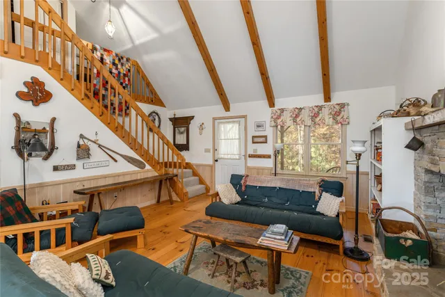 a living room with furniture and stairs