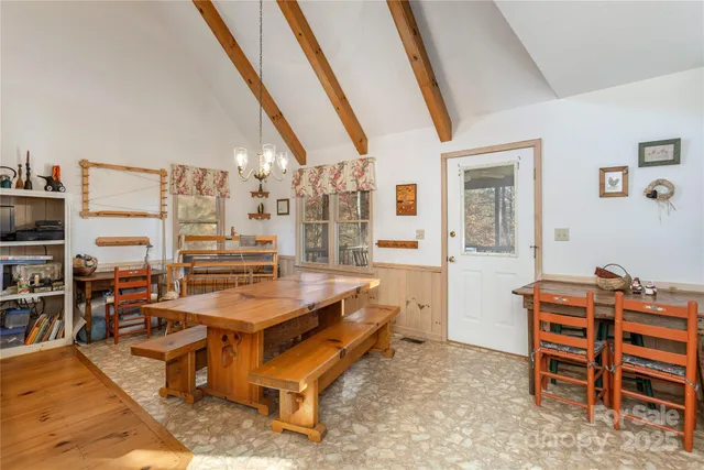 a room with furniture a air conditioner vent and a window