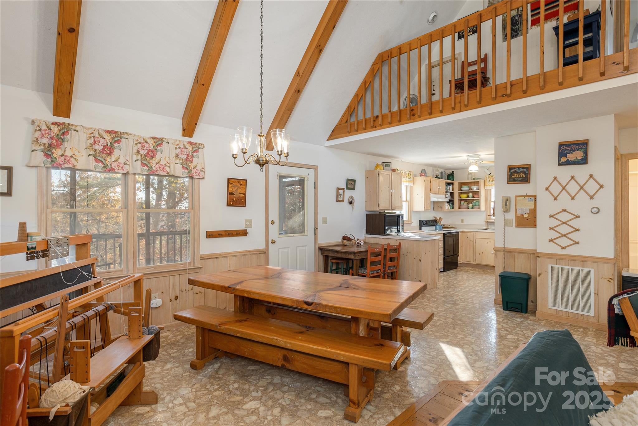 2355 Round Mountain Road Brevard, NC 28712 - Photo 9 of 27 a living room with furniture a flat screen tv and a floor to ceiling window