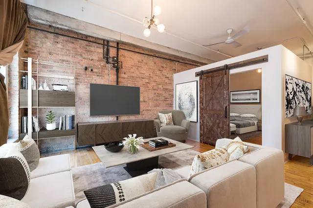 a living room with furniture and a floor to ceiling window