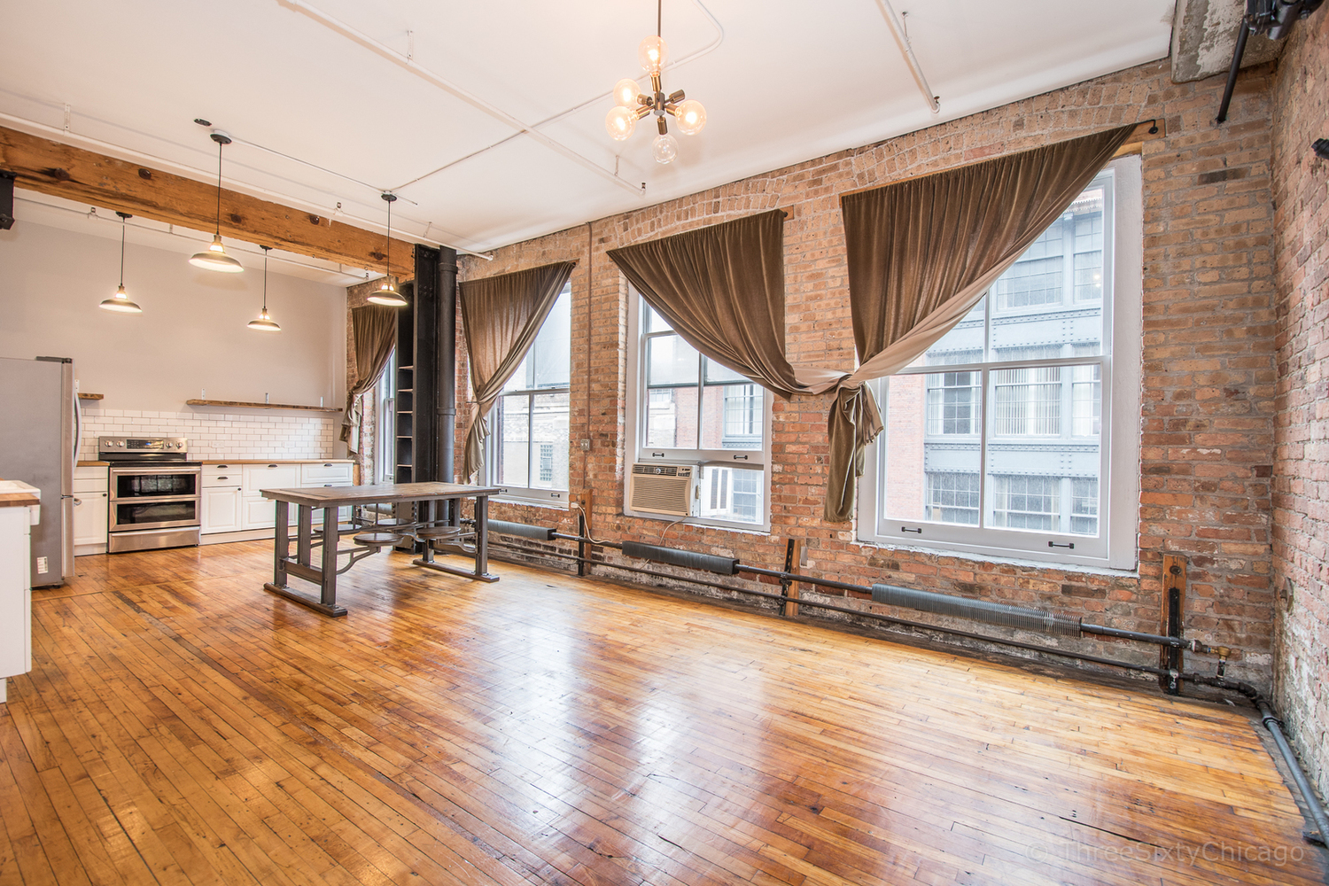 711 South Dearborn Street, Unit 508 Chicago, IL 60605 - Photo 9 of 16 an empty room with wooden floor and large windows
