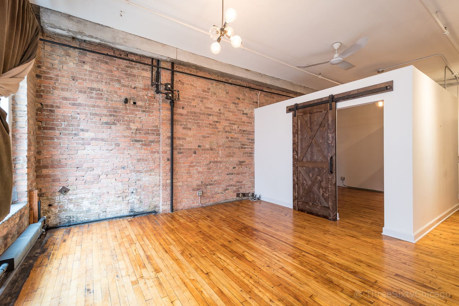 711 South Dearborn Street, Unit 508 Chicago, IL 60605 - Photo 10 of 16 a view of empty room with wooden floor and fan