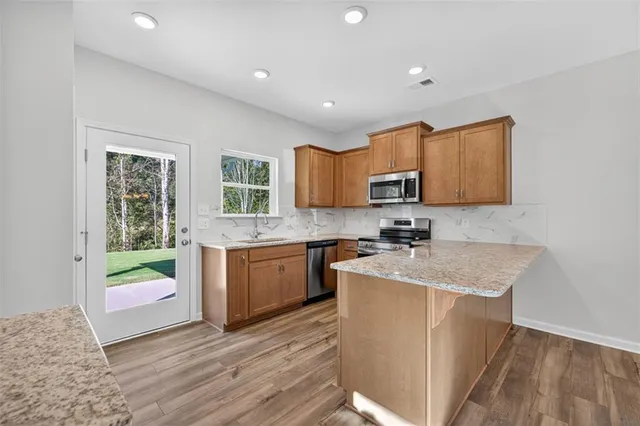 a kitchen with a sink stove and microwave